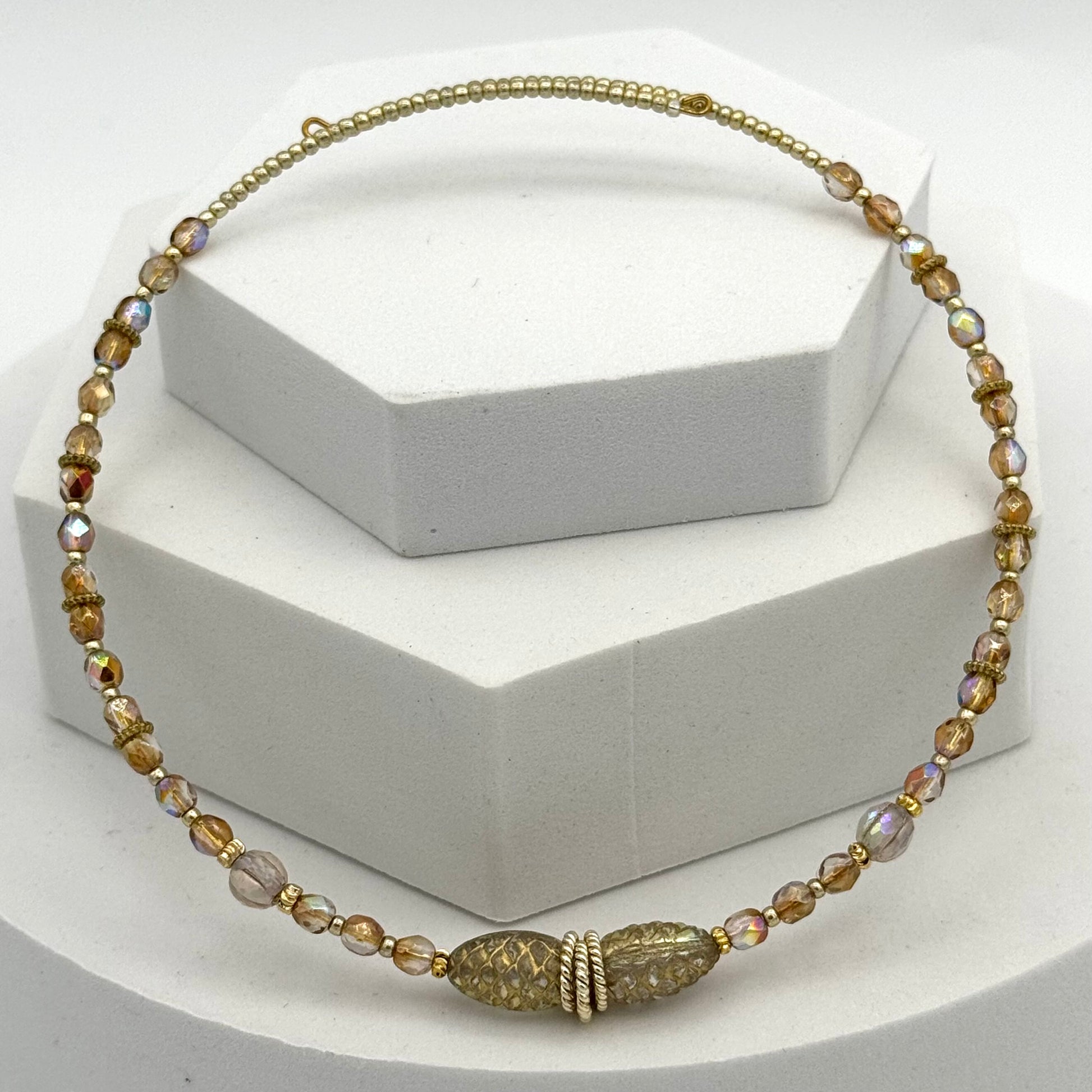 Necklace with gold and brown beads on a white background