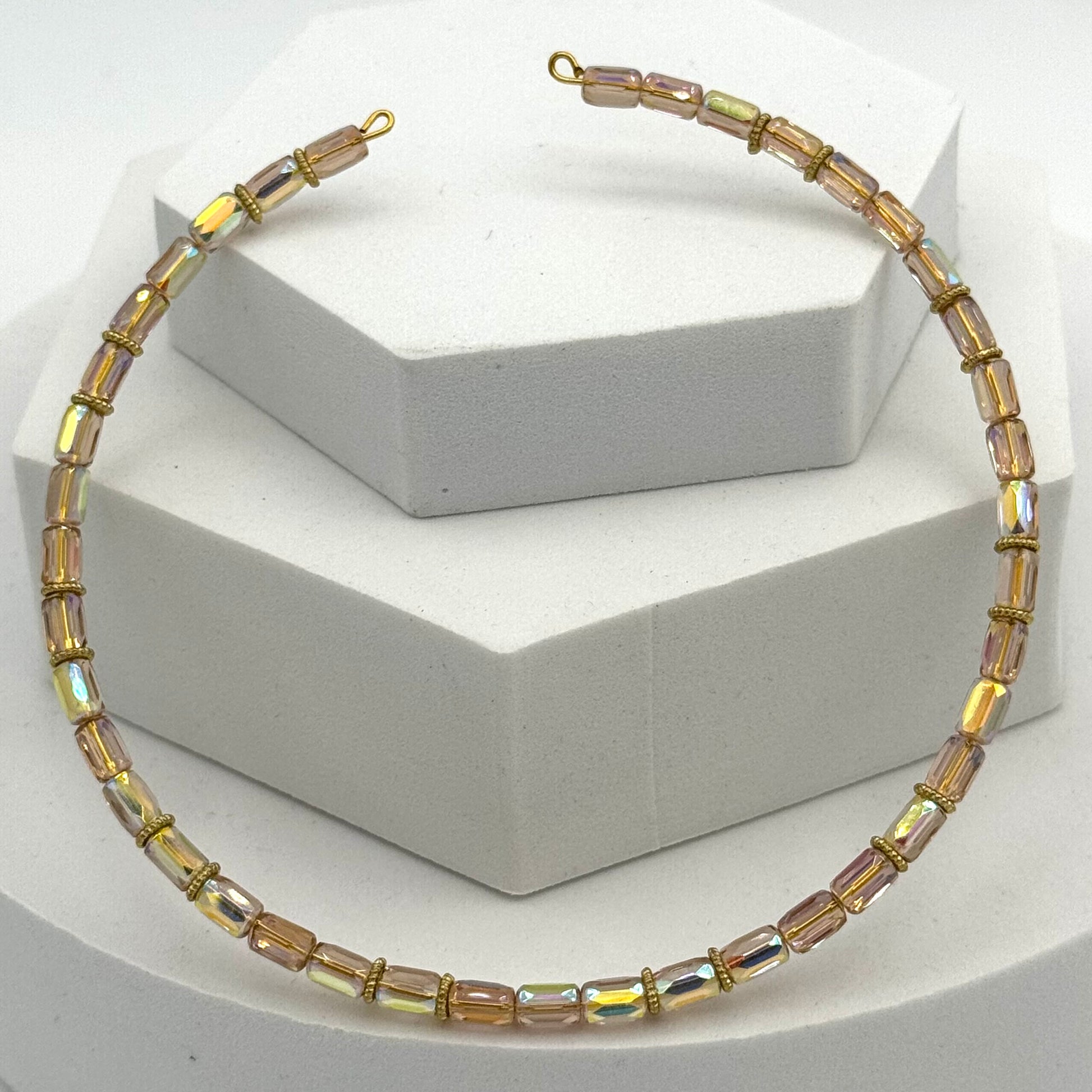 Necklace with multicolored beads on a white stand
