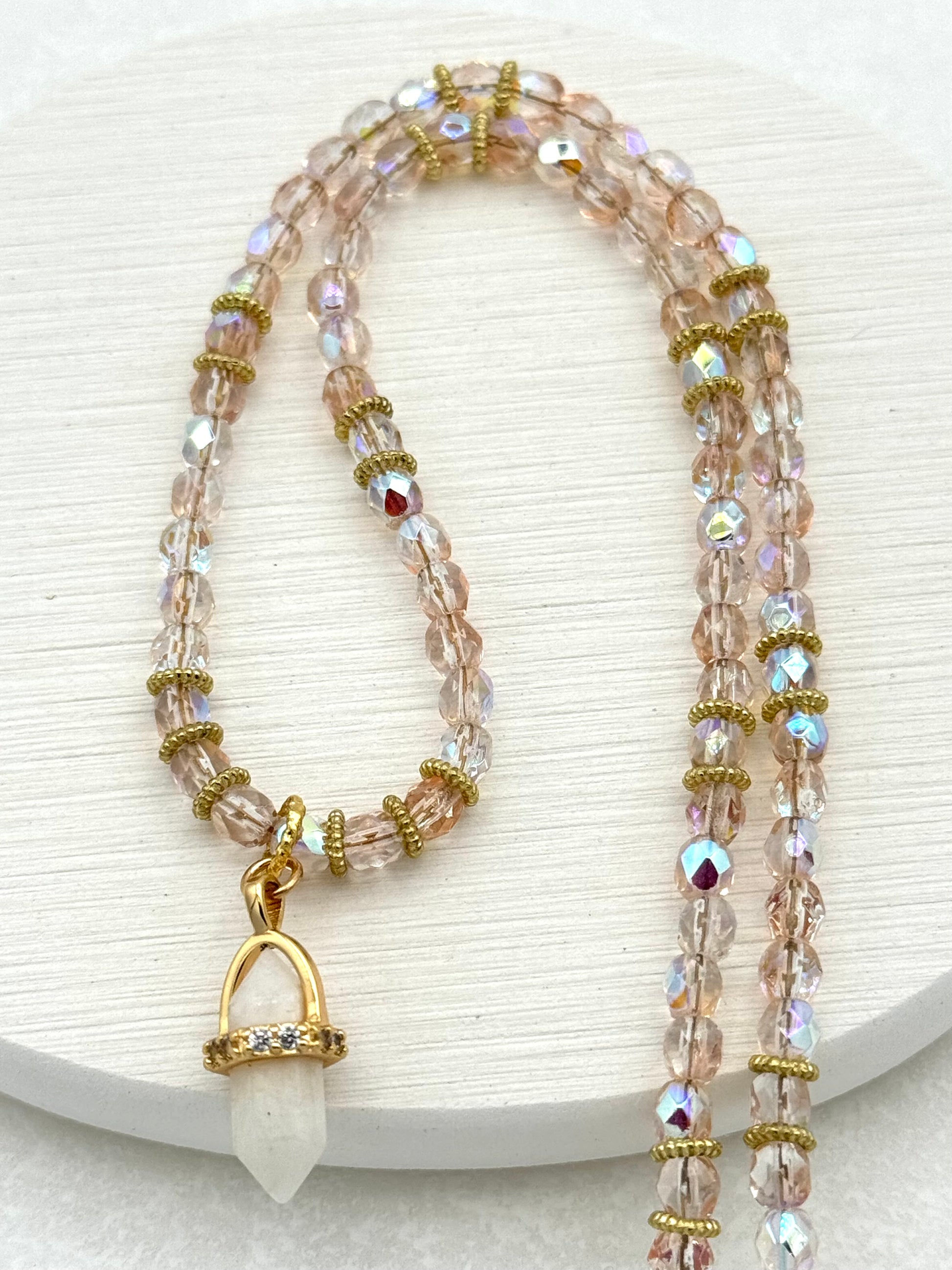 Necklace with beaded design and gold accents on a white background