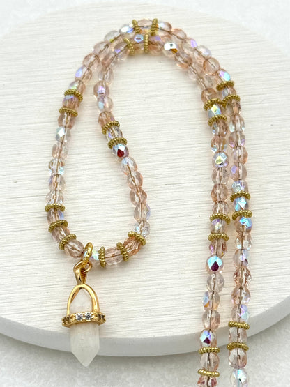 Necklace with beaded design and gold accents on a white background