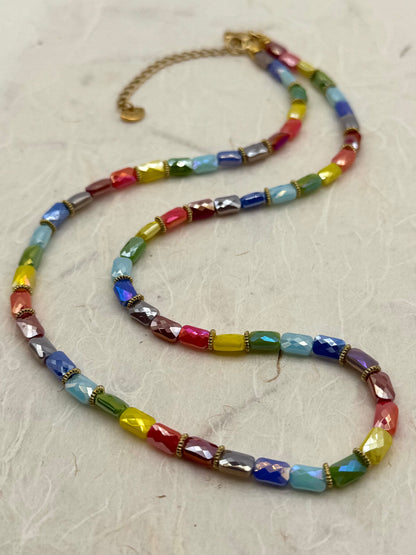 Colorful beaded necklace on a light gray surface