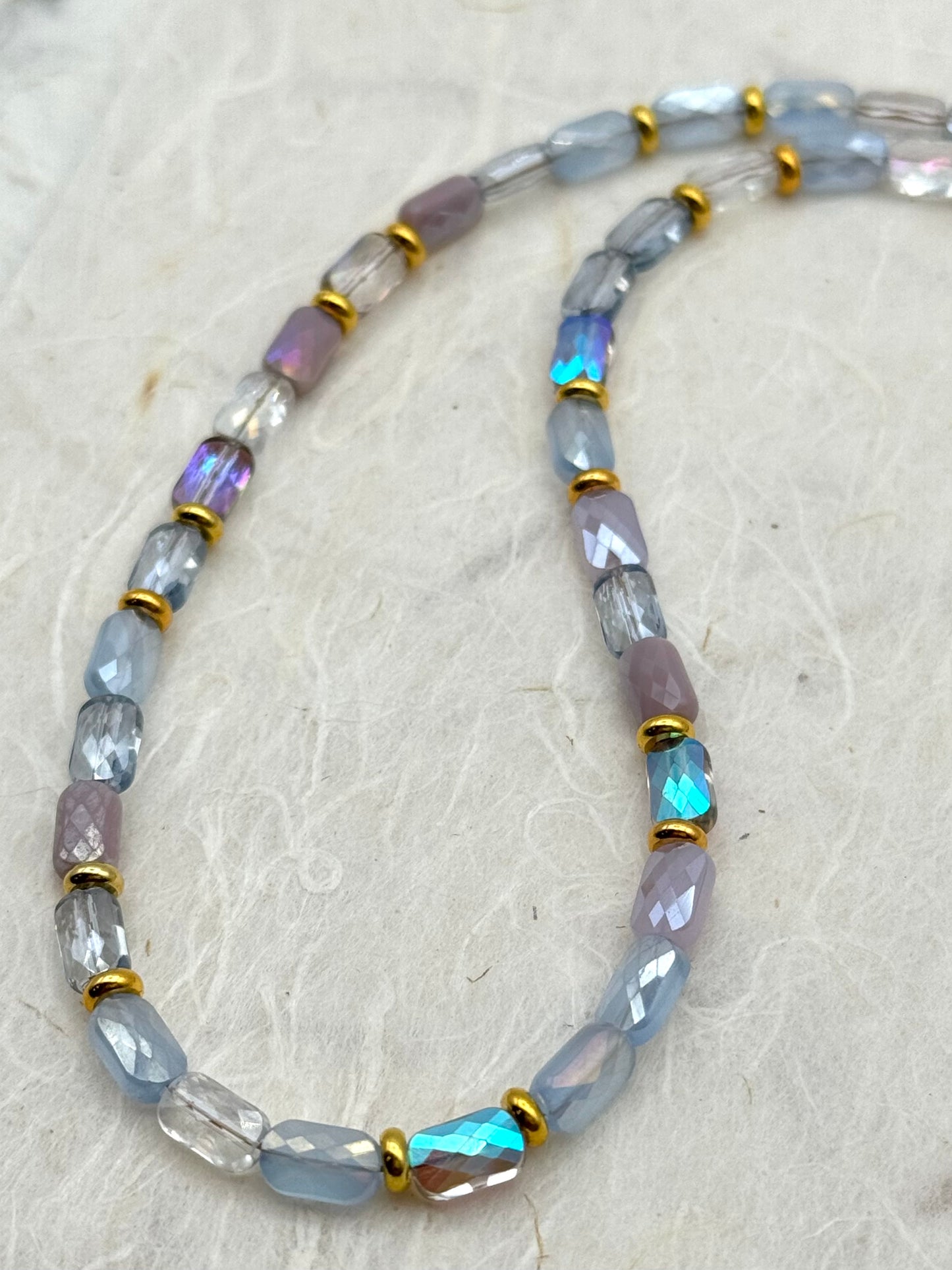 Necklace with multicolored beads on a textured surface