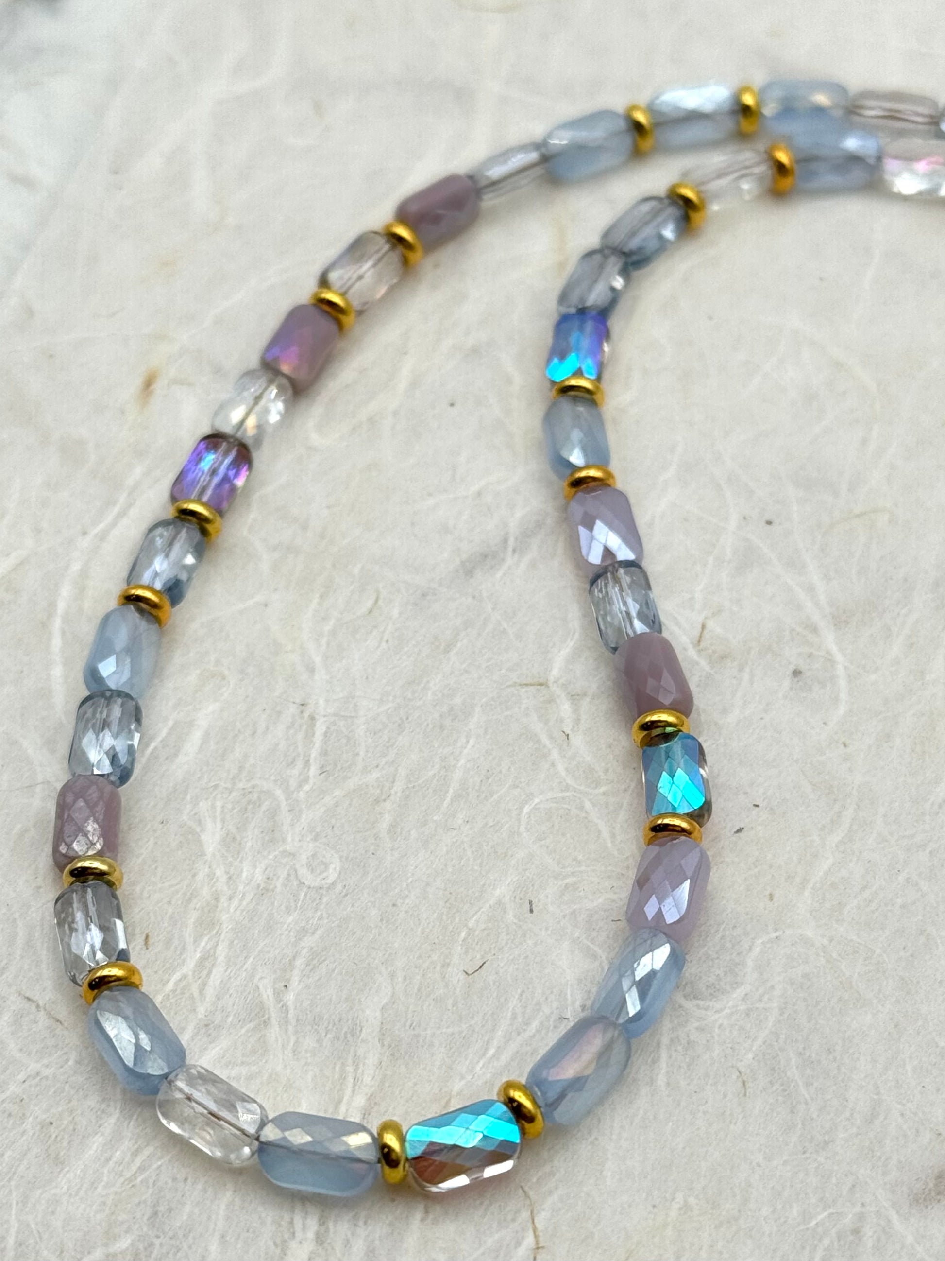 Necklace with multicolored beads on a textured surface
