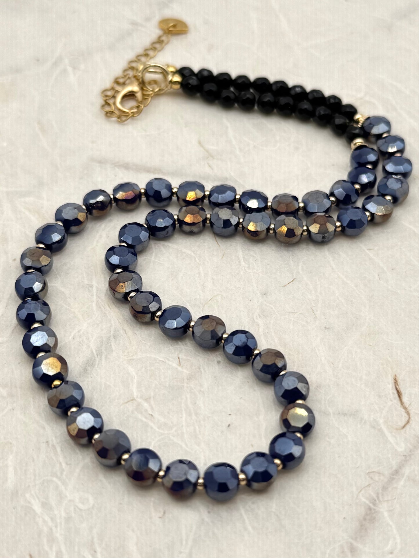 A beaded necklace on a textured surface