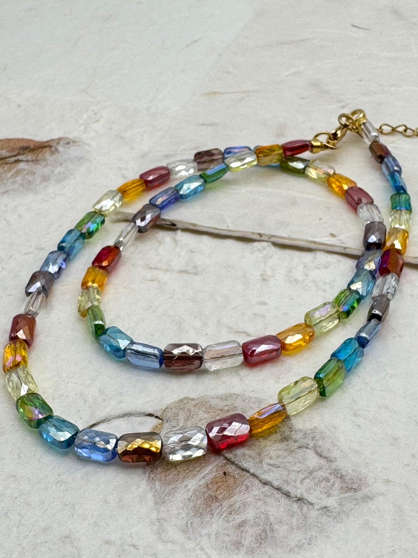 Multicolored beaded necklace on a textured surface