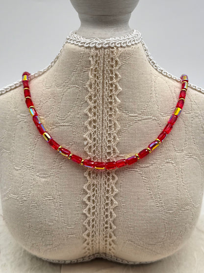 Necklace with red beads on a mannequin bust with lace details
