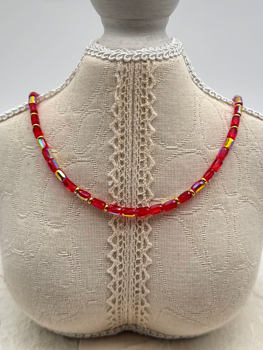 Necklace with red beads on a mannequin bust with lace details