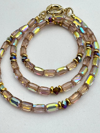 Beaded bracelet with iridescent beads on a light gray background