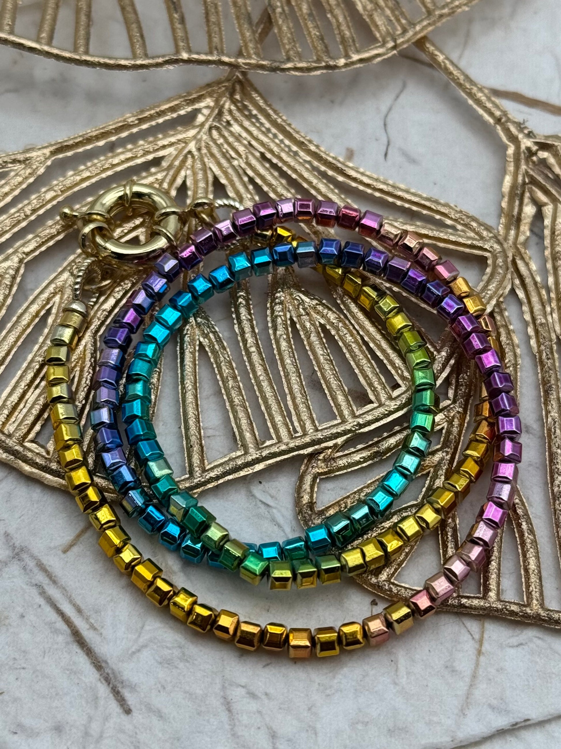 Multicolored beaded bracelet on a decorative gold background