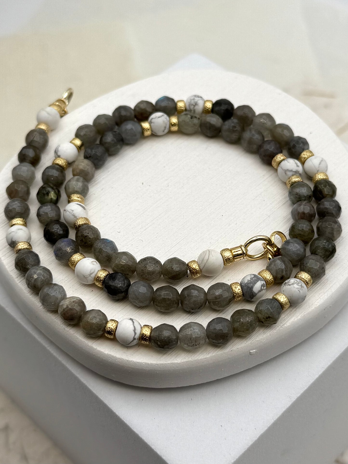 Set of beaded necklaces on a white surface