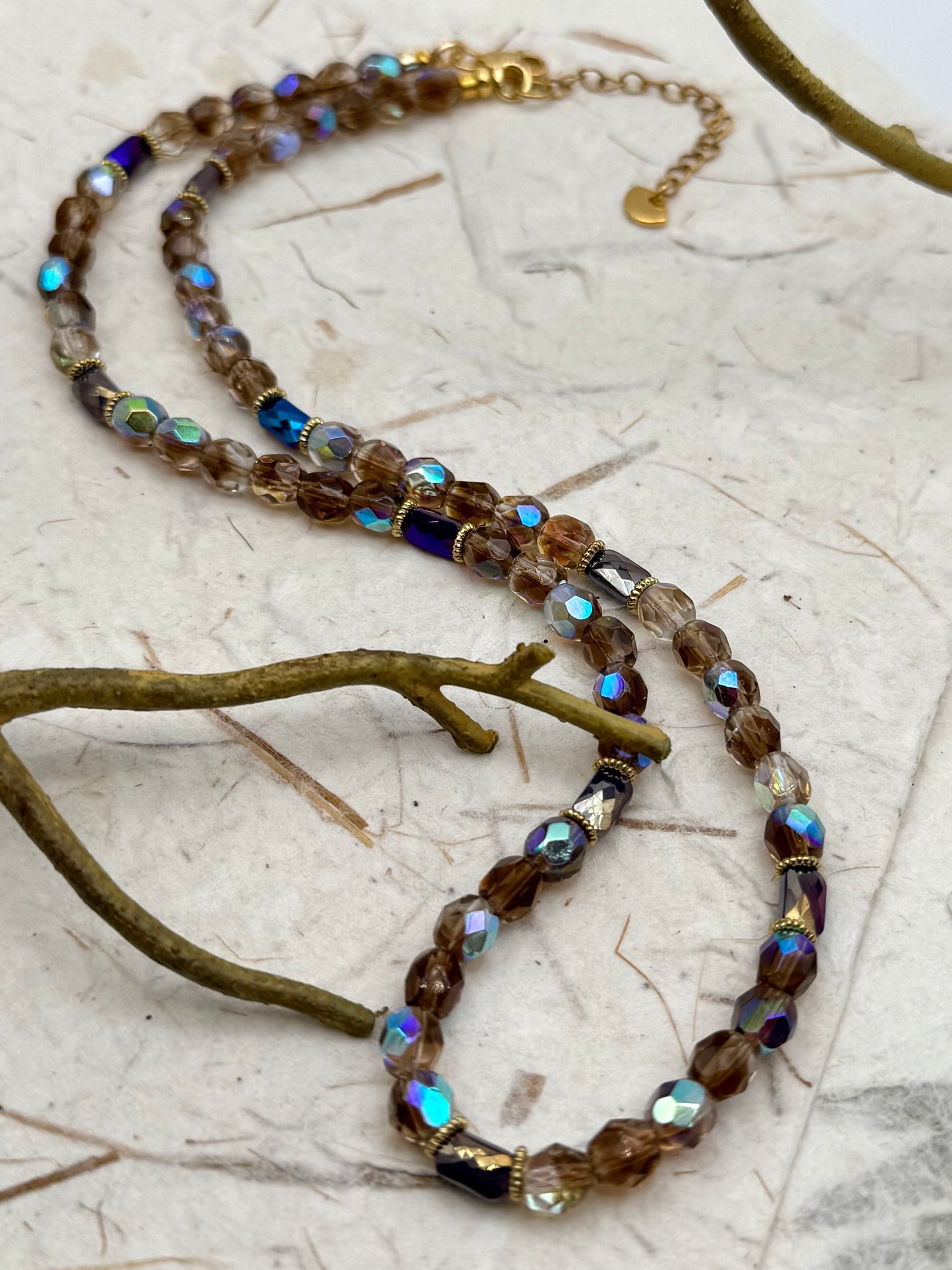 Beaded necklace with multicolored beads on a textured surface