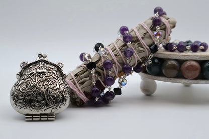 Decorative item with intricate design, beads, and a small stand on a white background