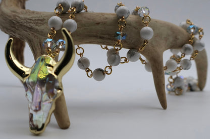 Bracelet with cow skull charm and beads on a wooden surface