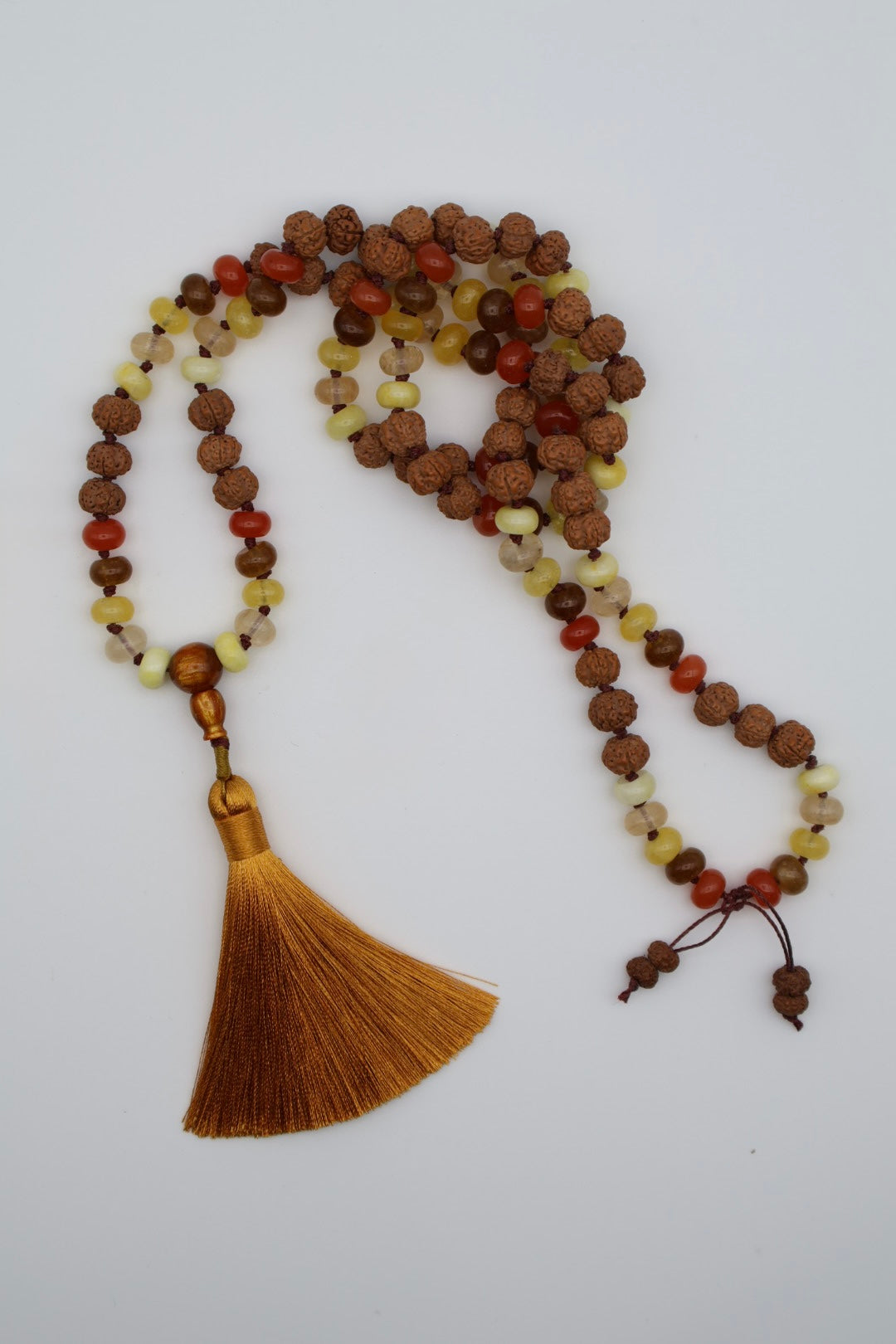 Meditation necklace with beads and tassel on a white background