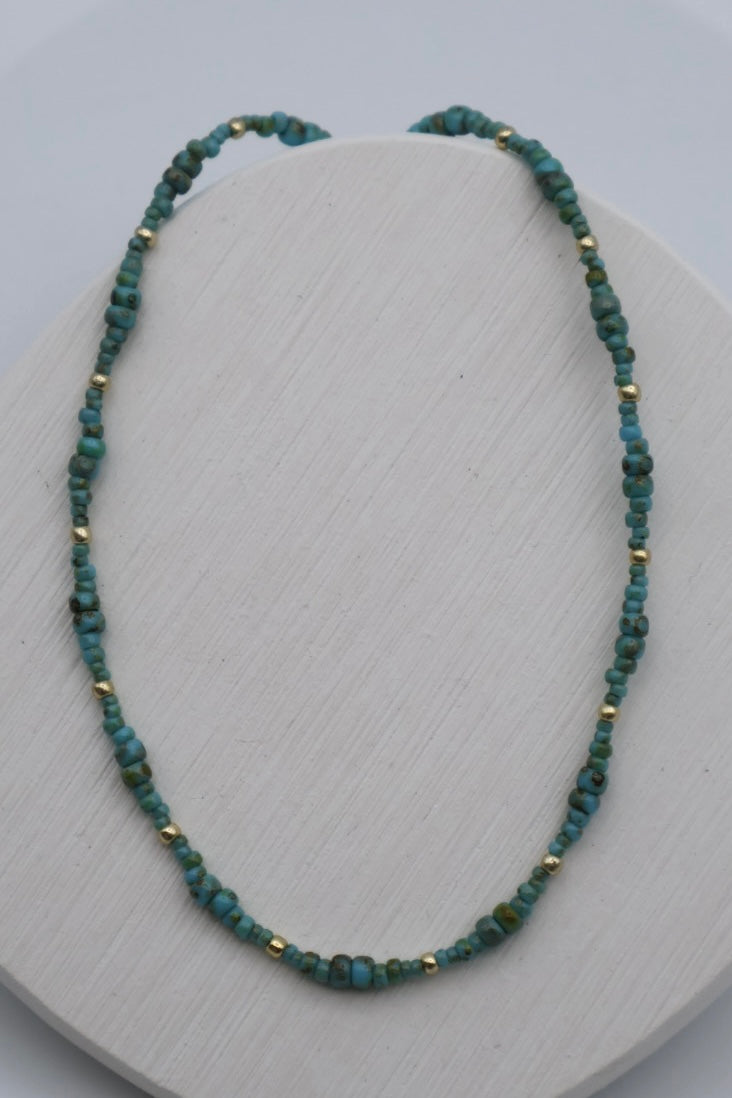 Necklace with green beads on a white surface