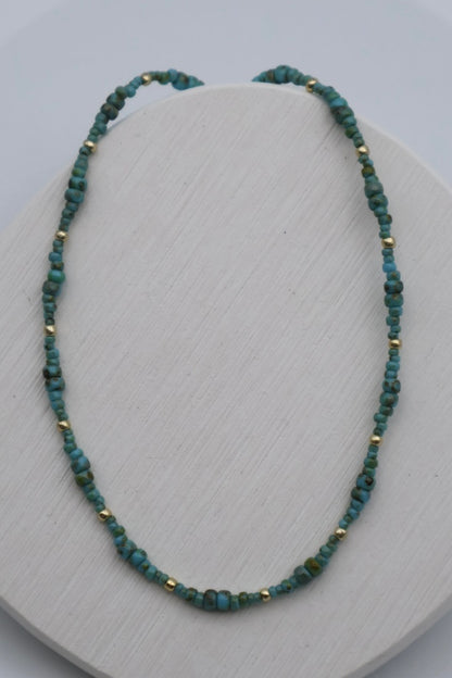 Necklace with green beads on a white surface