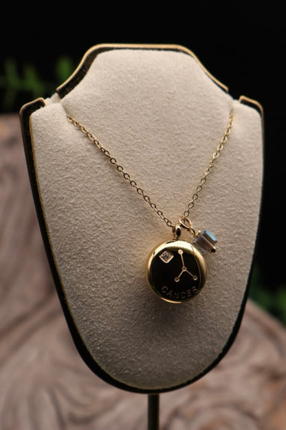 Gold necklace with a pendant on a white bust