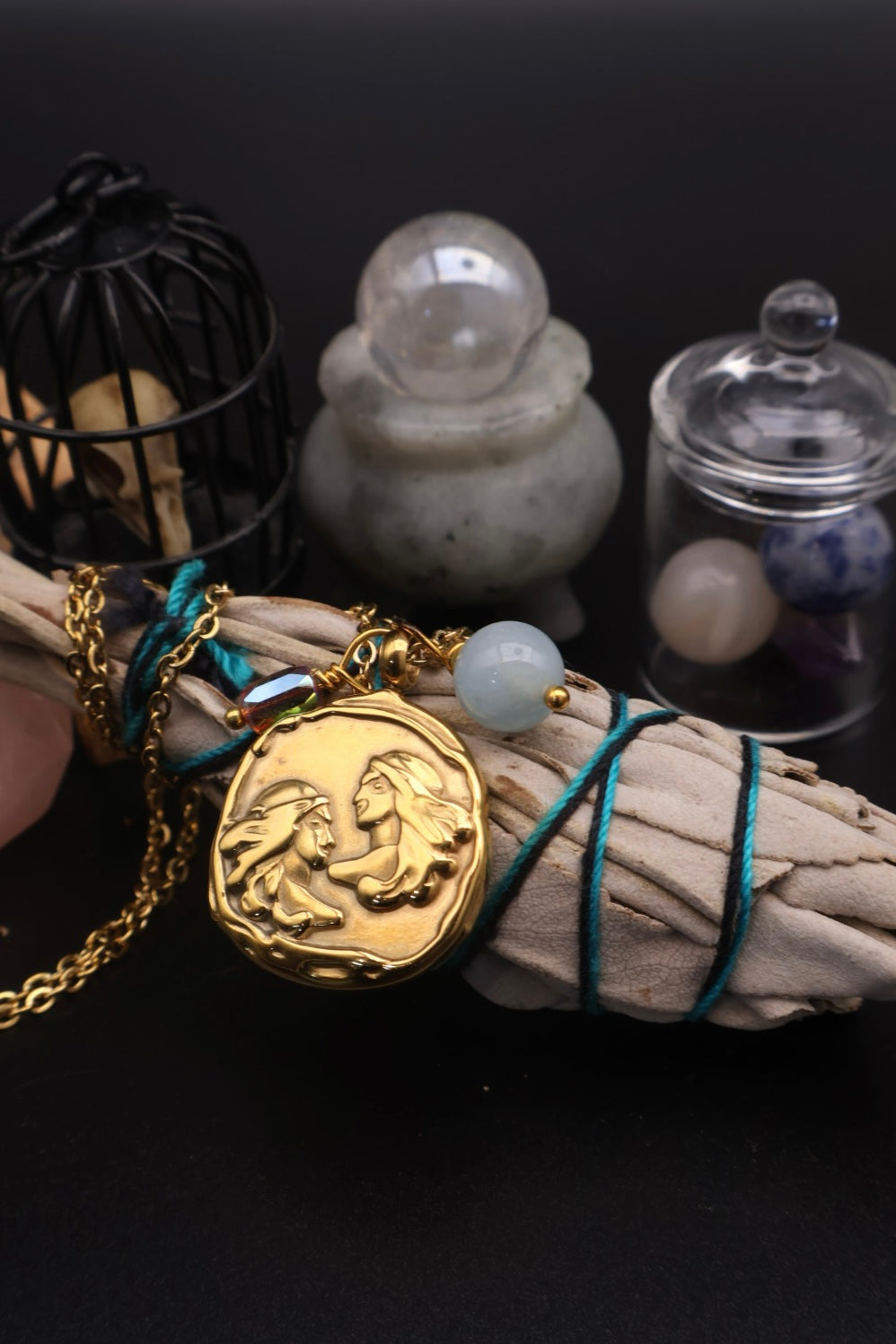Gold pendant on a string with a black background