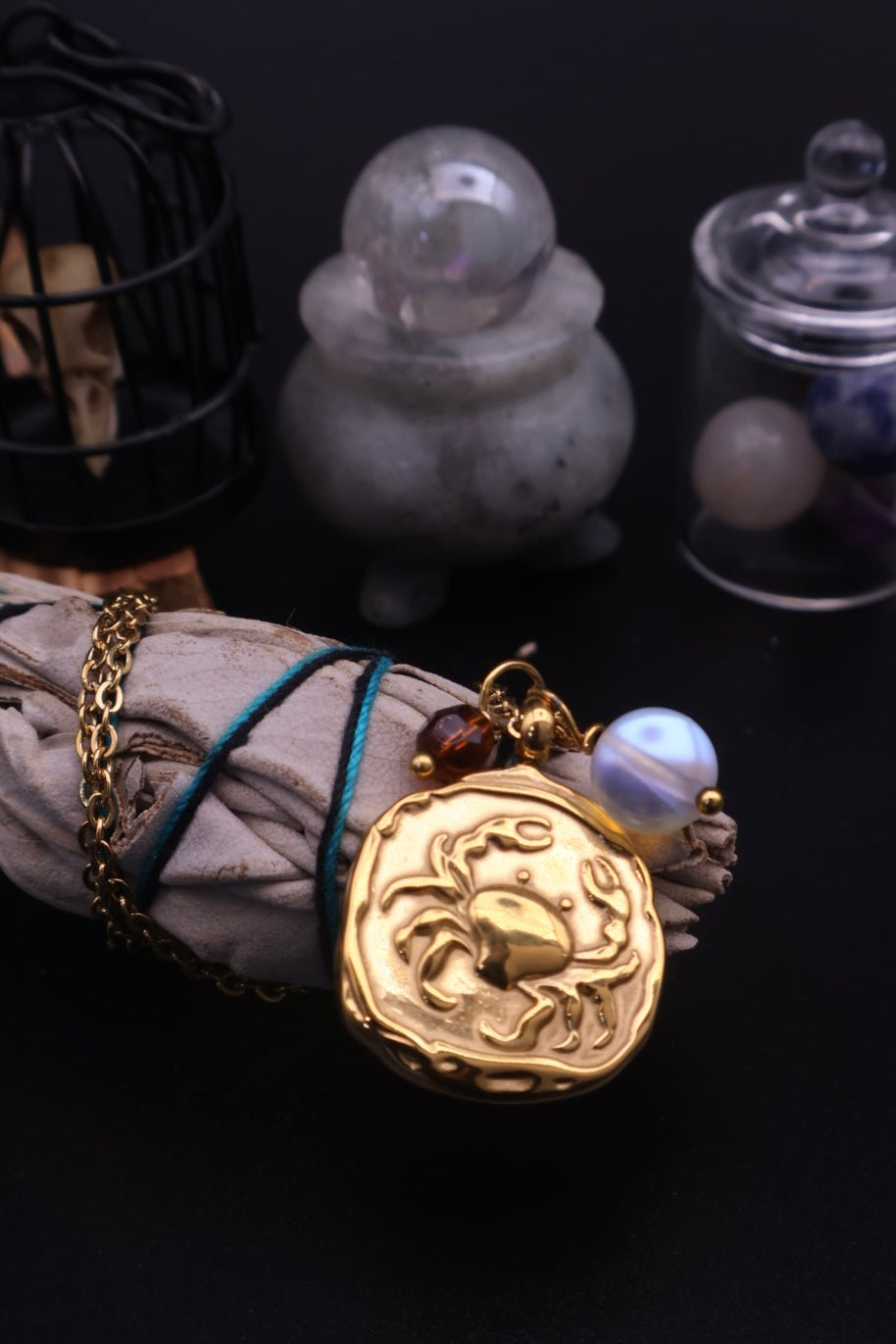 Gold pendant with a design on a dark background