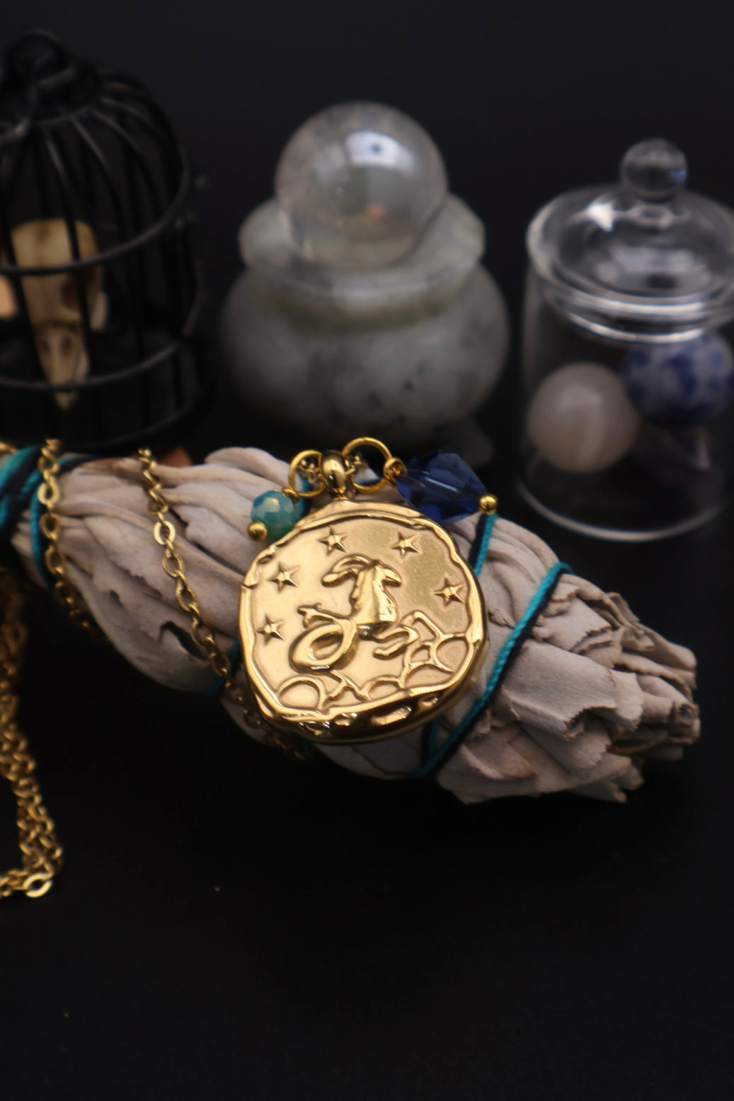Gold pendant with star design on a dark background
