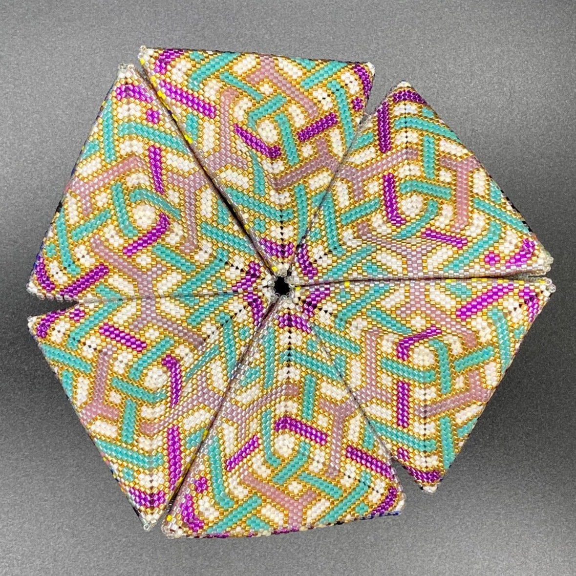 Decorative kaleidocycle with a geometric pattern on a gray background