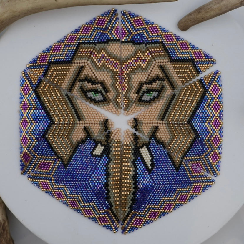 Decorative hexagonal pattern with a face design on a white surface