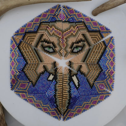 Decorative hexagonal pattern with a face design on a white surface