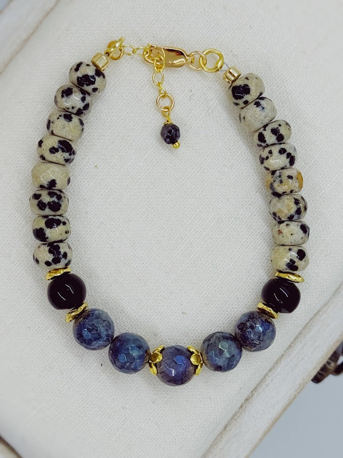 a bracelet made with Dalmatian jasper, labradorite, and onyx beads