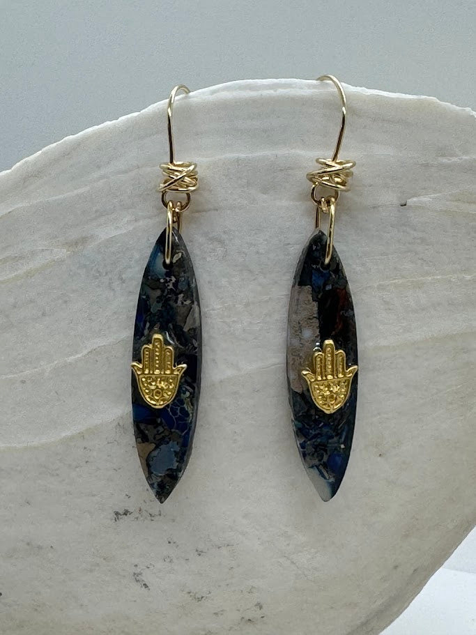 Multiple pairs of Gemstone Earrings featuring different gemstones such as amethyst, citrine, and turquoise, displayed side by side.
