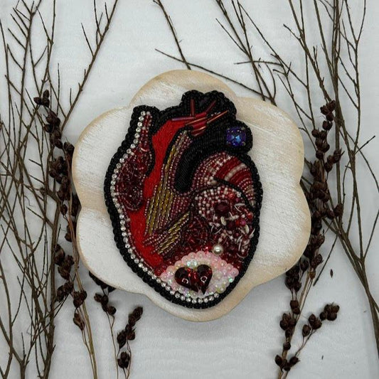 an anatomical bead embroidered heart