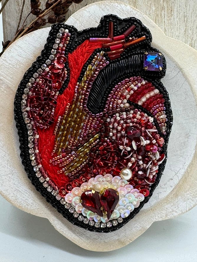 a closeup of a beaded anatomical heart.