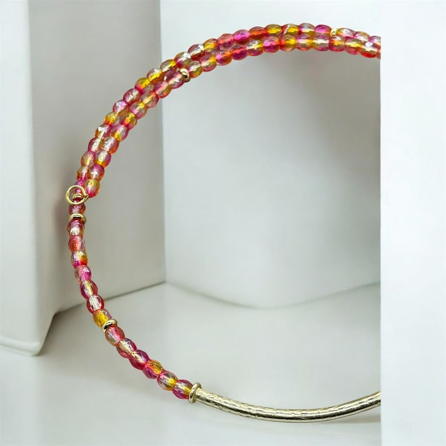 a closeup of a pink and yellow choker