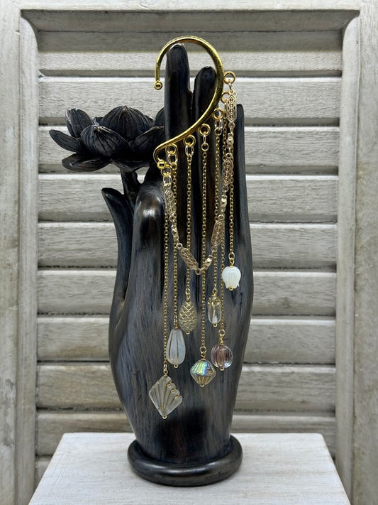 an ear hanger with baroque style beads on gold chains.