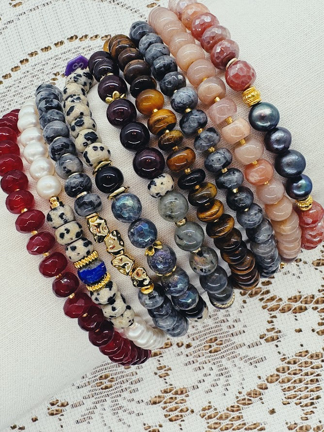 a close up of nine gemstone bracelets with various gemstone beads and imitation gemstone beads