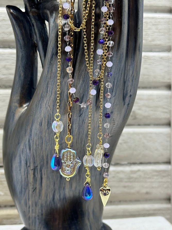 charms and beads hanging off gold and beaded chains