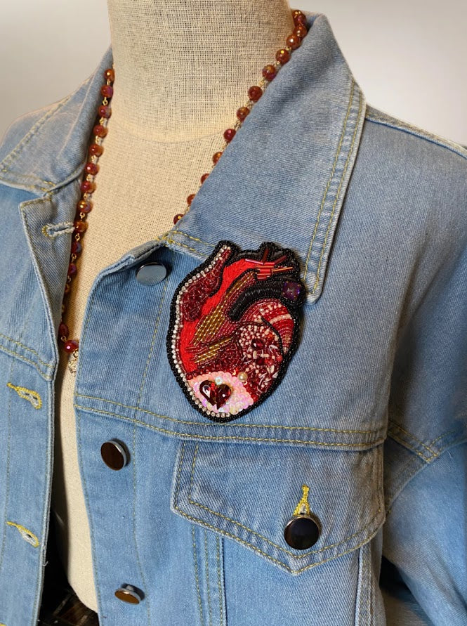 an anatomical bead embroidered heart on a demin Jacket